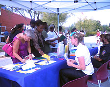 Lead planner Kristin O'Connor staffs a table at Burtonsville Day.